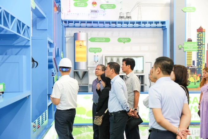 Đoàn công tác tìm hiểu quy trình xử lý và phát điện từ rác thải tại khu trưng bày mô hình vận hành nhà máy.